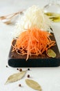 Slicing Fresh cabbage and carrots on a wooden board on a light background. Vegetables for ferment, for long fermentation. Royalty Free Stock Photo