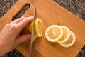 Slicing a fresh lemon Royalty Free Stock Photo