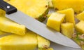 Slicing a fresh pineapple on a cutting board Royalty Free Stock Photo