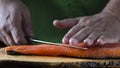 Slicing gravlax salmon with a knife Royalty Free Stock Photo