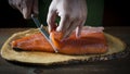 Slicing gravlax salmon with a knife Royalty Free Stock Photo