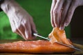Slicing gravlax salmon with a knife Royalty Free Stock Photo