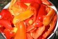 Slicing juicy sweet peppers in an enamel bowl.