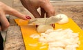 Slicing onions with a knife on the board Royalty Free Stock Photo