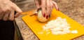 Slicing onions with a knife on the board Royalty Free Stock Photo