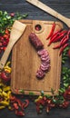 Slicing sausage on cutting Board with ingredients