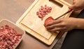 Slicing sausage with a knife on the board