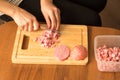 Slicing sausage with a knife on the board