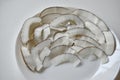 Slicing and shavings of coconut on a white plate Royalty Free Stock Photo
