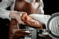 Slicing Spanish jamon iberico on cutting machine. Spanish jamon and traditional food. gastronomic products of Spain Royalty Free Stock Photo