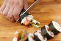 Slicing sushi with crab, salmon, cucumber Royalty Free Stock Photo