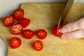 Slicing tomatoes on an old textured board