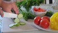 Slicing vegetables on the kitchen table at home. Healthy food, home cooking, diet food.