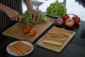 Slicing vegetables to prepare ingredients for making hot dogs