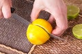 Slicing zested lemon with knife. Royalty Free Stock Photo