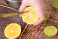 Slicing zested lemon with knife. Royalty Free Stock Photo