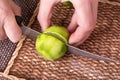 Slicing zested lime with knife. Royalty Free Stock Photo