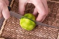 Slicing zested lime with knife. Royalty Free Stock Photo