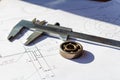 Slide caliper and ball bearing lie on a drawings Royalty Free Stock Photo