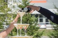 A slide of champagne. Pyramid of champagne glasses with red cherries.