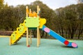 Slide children`s wooden blue yellow red color on the Playground in the city outdoors. Kids games sports Royalty Free Stock Photo