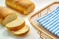A slide homemade white bread on a cooling rack with a cloth on white table Royalty Free Stock Photo