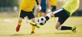 Slide Tackle in Soccer Match. Two Young Soccer Players in a Duel Compete For Ball. Teenage Players Playing Football Game