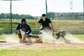 Sliding into base is his thing. Full length shot of a young baseball player reaching base during a match on the field. Royalty Free Stock Photo