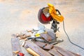 Sliding Compound Miter Saw with a Pile of Laminate Offcuts Outdoors