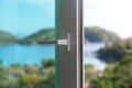 Sliding door of a balcony. Close-up of the lock on the door with and nice landscape of background. Royalty Free Stock Photo