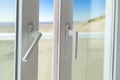 Sliding door from a balcony to the beach. Closeup of door lock Royalty Free Stock Photo