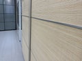 Sliding doors of modern wardrobe, case compartment with brown wooden dood panels in a hallway of a house Royalty Free Stock Photo