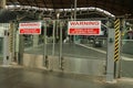 Sliding Gates Open Without Notice warning sign at a railway station