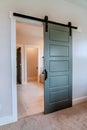 Sliding gray wooden panel door that leads to the bathroom of a home Royalty Free Stock Photo