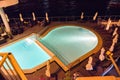 Tourists relaxing near a swimming pool at night Royalty Free Stock Photo