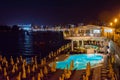 Tourists relaxing near a swimming pool at night Royalty Free Stock Photo