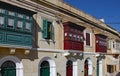 SLIEMA, MALTA - NOVEMBER 5TH 2019 :Traditional multicoloured wooded balcony windows overlook the road in the back streets of Malta Royalty Free Stock Photo