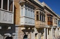 SLIEMA, MALTA - NOVEMBER 5TH 2019 :Traditional multicoloured wooded balcony windows overlook the road in the back streets of Malta Royalty Free Stock Photo