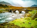 Sligachan Old stone Bridge over River Sligachan with Beinn Dearg Mhor and Marsco peak of Red Cuillin mountains in Royalty Free Stock Photo