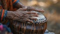 Slightly blurred fingers dance over the taut surface of a tabla drum creating an intricate and soothing rhythm that