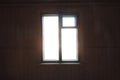 Slightly blurry view of  dark empty room and light window , sunlight shining through window of  old country house, dark empty room Royalty Free Stock Photo