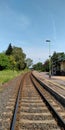 Slightly curved rail road at a train station