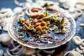 Slightly high angle shot of a glass plate full of Chole bhature in it on a black background along with some phudina/mint chutney a