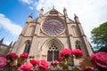 slightly oblique view of a large rose window on a stone cathedral