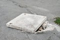 Slightly open manhole on the roadway in Vladivostok Royalty Free Stock Photo