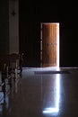 A slightly open wooden door with a metal bolt