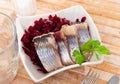 Slightly salted herring slices with grated beets and greens