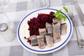 Slightly salted herring slices with grated beets and greens