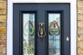 Striking front door with stained glass and a goat head door knocker