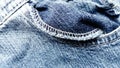 A slightly twisted pocket in jeans. Blue shabby denim. An overcast machine seam around the edge of the inside of the pocket. Royalty Free Stock Photo